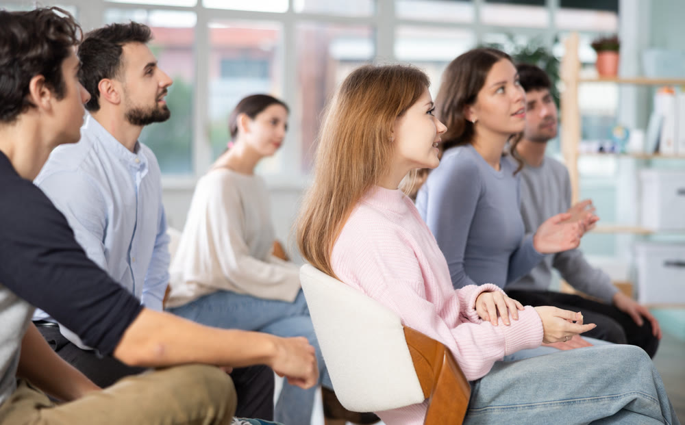 Young people are listening to lecture in auditorium
