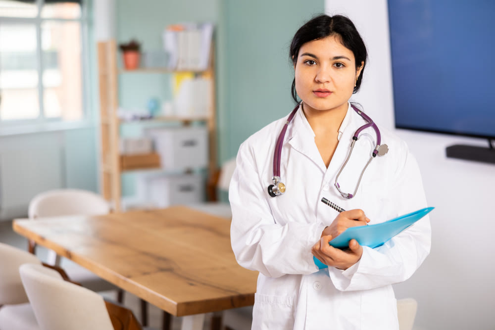 Doctor woman with document stands in office space