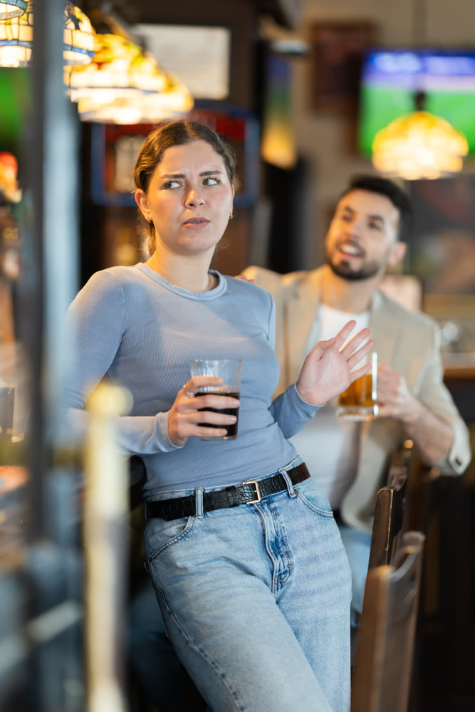 Guy is rejected while trying to pick up girl at bar.