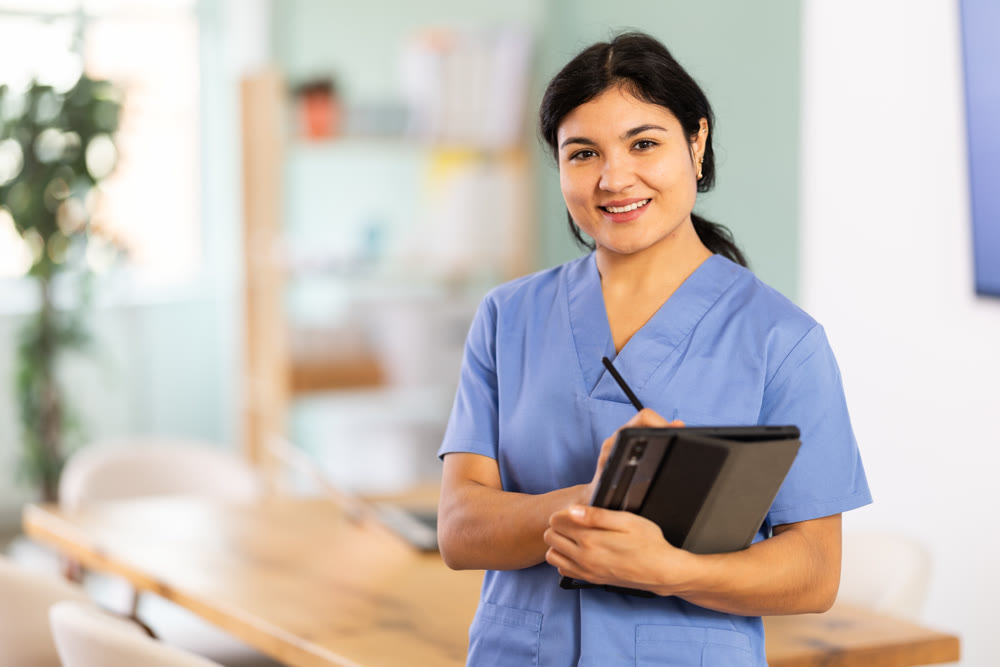 Doctor woman with tablet stands in office space