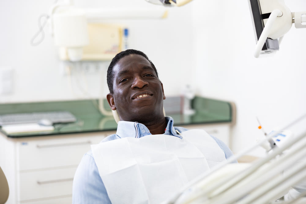 Portrait of satisfied male patient in dental chair