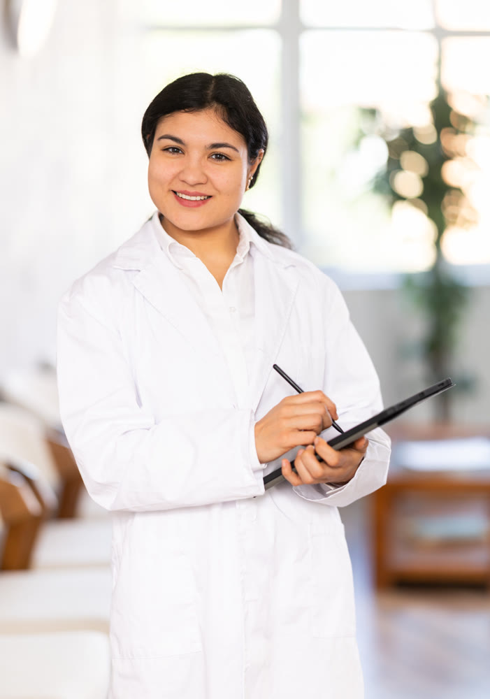 Portrait of friendly female medical receptionist with tablet
