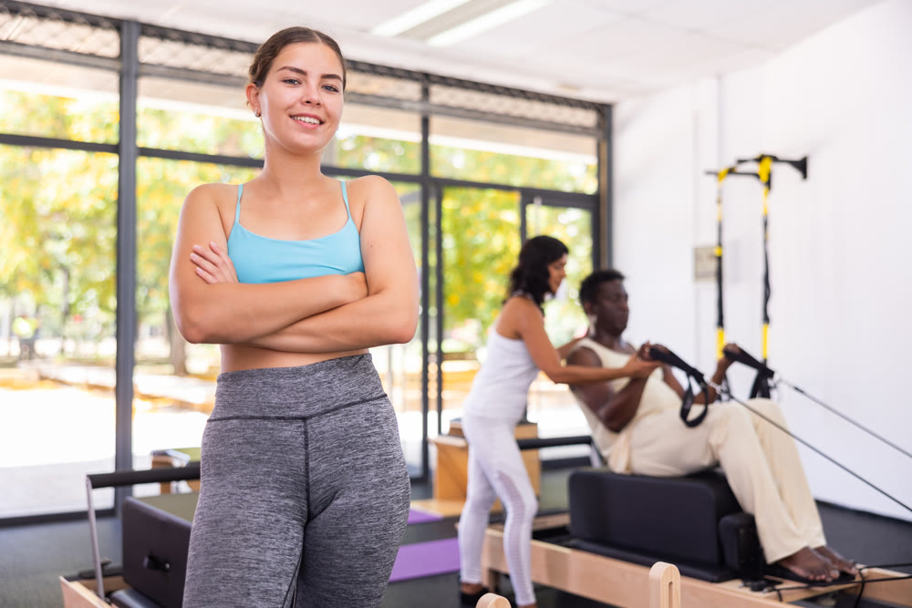 Portrait of girl in sportswear posing in pilates studio. Healthy lifestyle and fitness concept