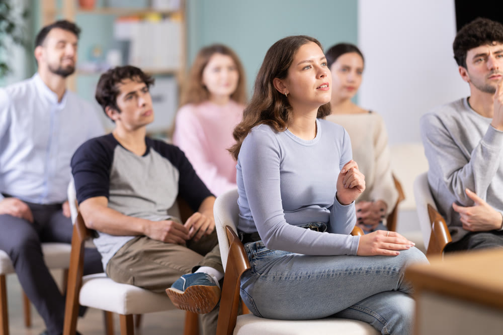 Young people are listening to lecture in auditorium