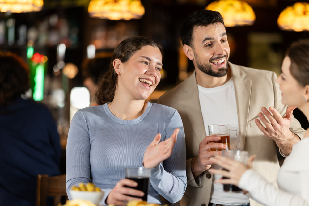Man flirting with woman, they smile at each other