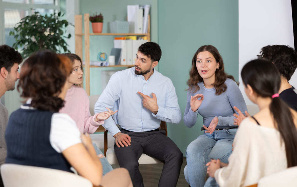 Group of students sitting in a circle and chatting