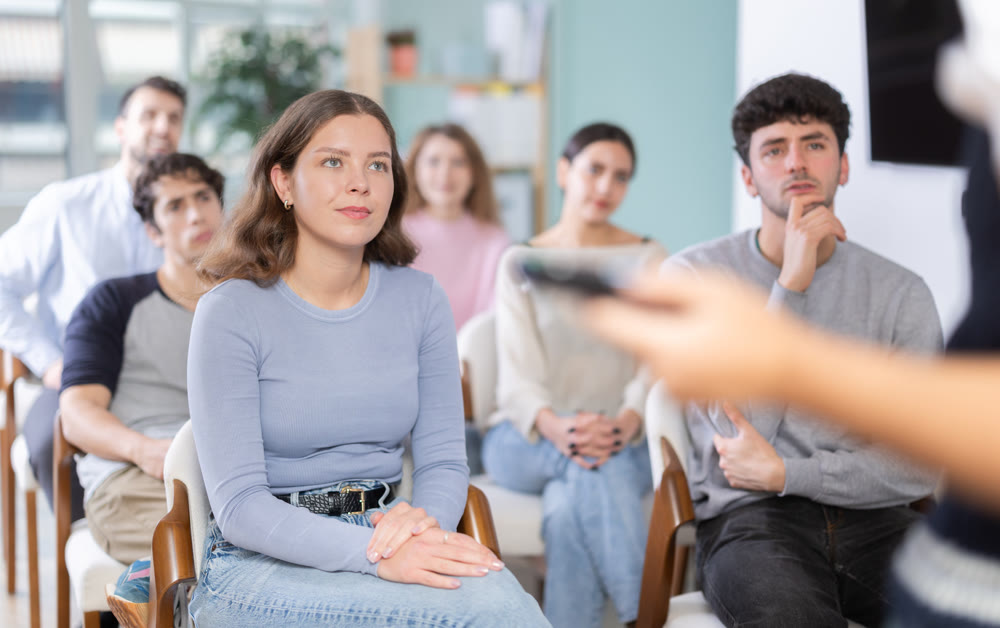 Young people are listening to lecture in auditorium