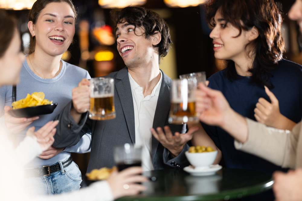 Group of friends happily having time at bar