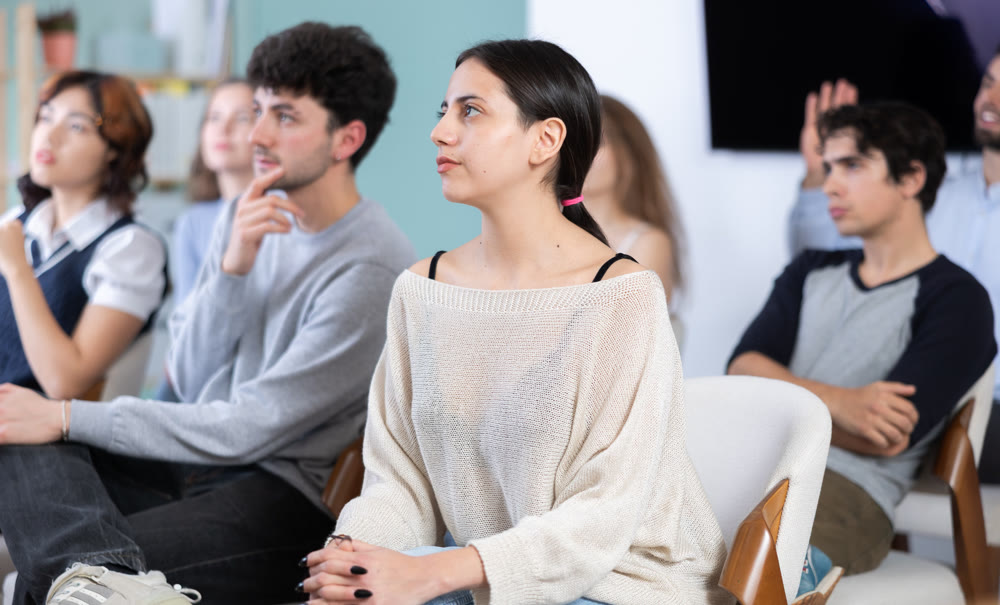 Students sit attentively in the classroom and listen to lectures