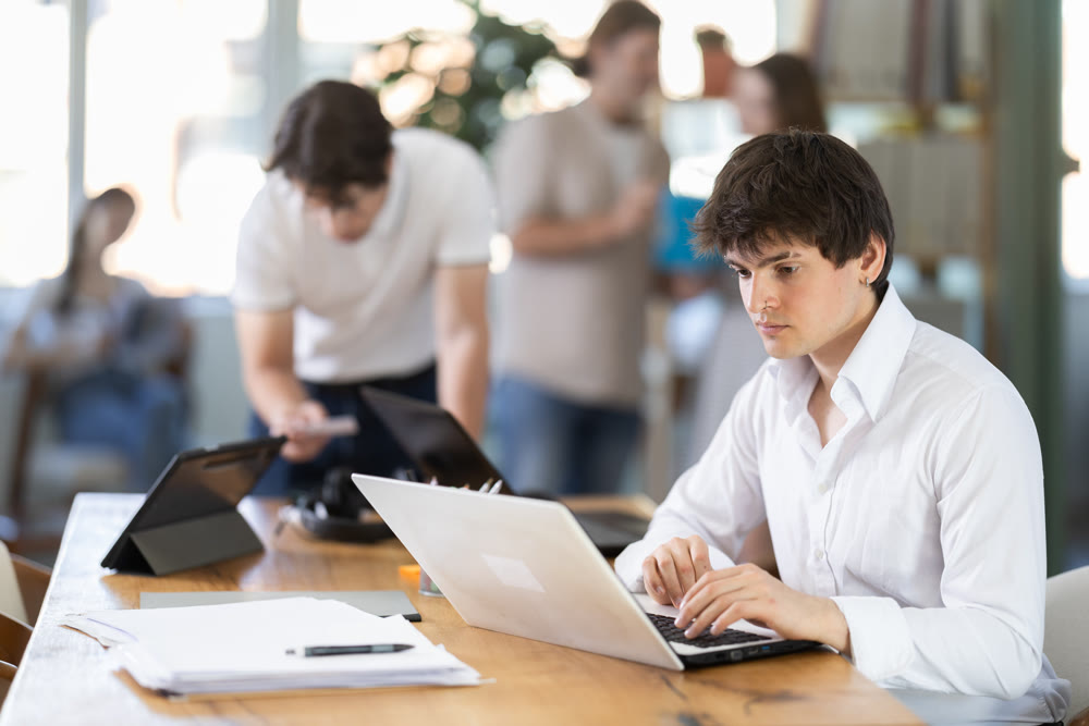 Young man working on laptop in modern office