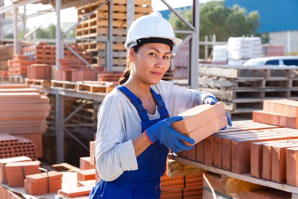 Asian woman worker is laying bricks