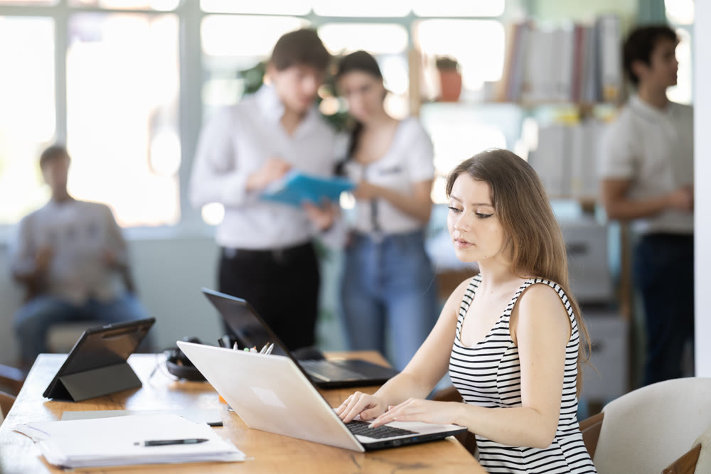 Working in modern office - businesswoman working on laptop