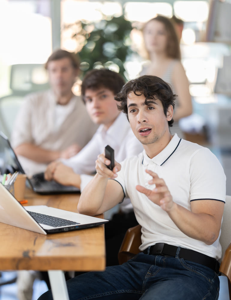 Group of colleagues watching presentation in office