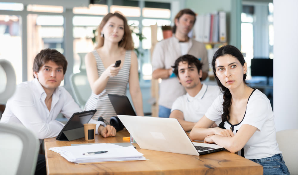 Male and female colleagues watching presentation in office