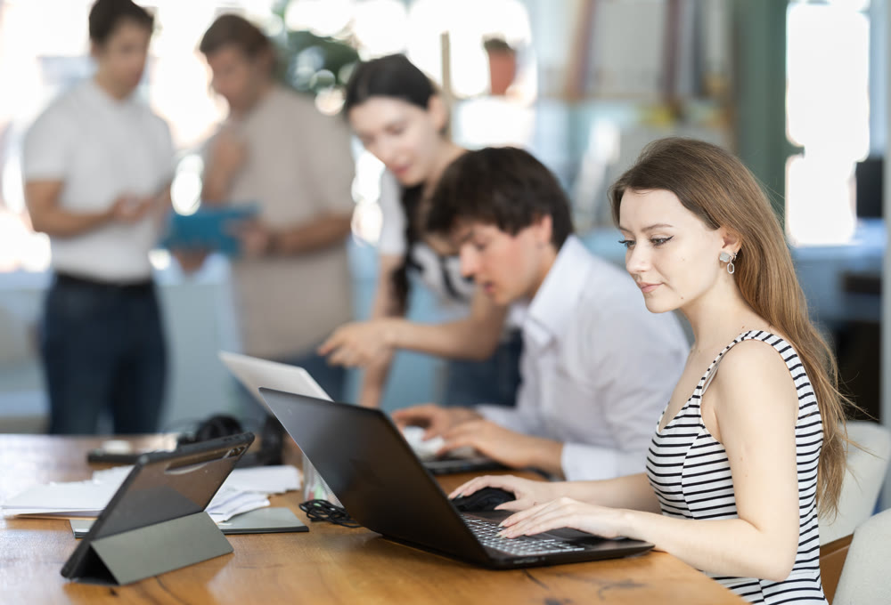 Several managers work together in a modern office. Well-coordinated management team
