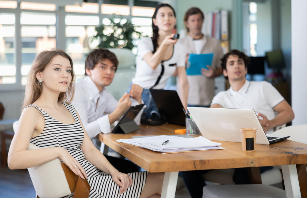 Group of colleagues watching presentation in office