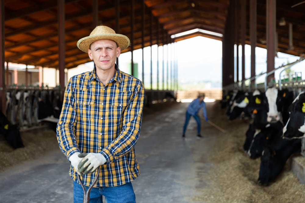 Portrait t worker standing in the yard of a livestock farm