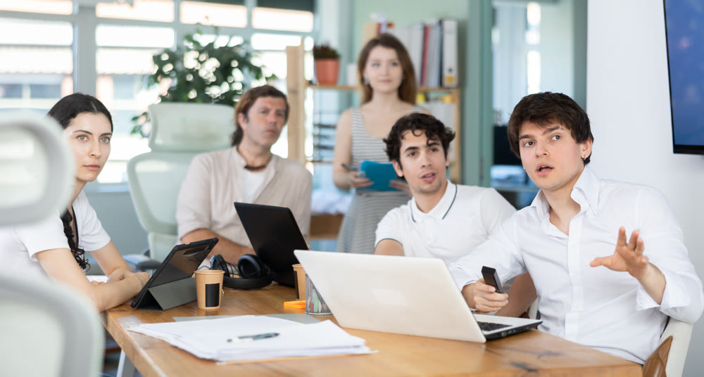Group of colleagues watching presentation in office