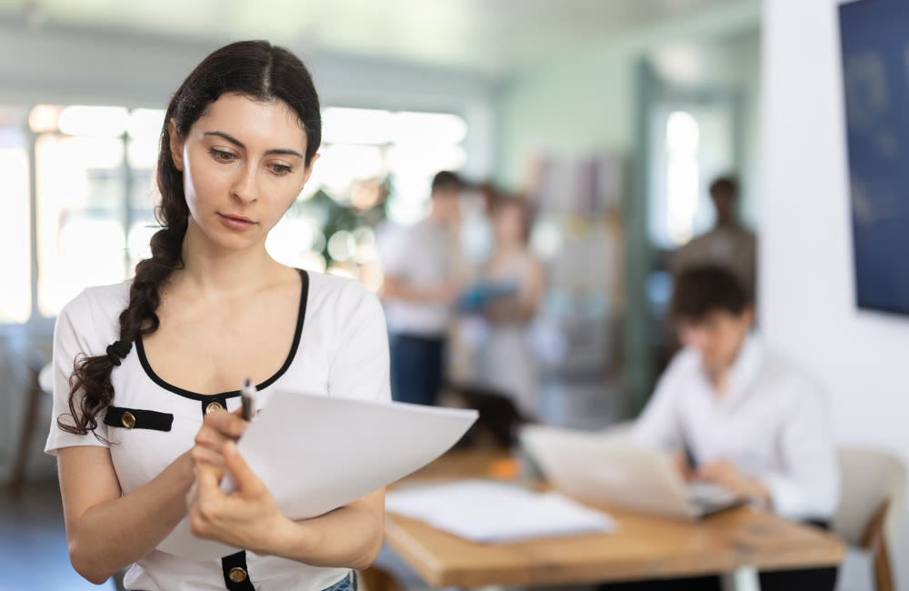 Female worker with a documents in his hands in office