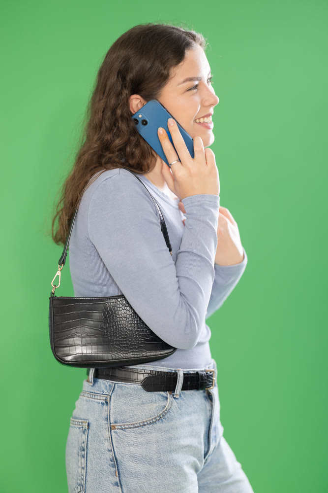 Happy girl is talking to someone on mobile phone. Chroma key compositing.