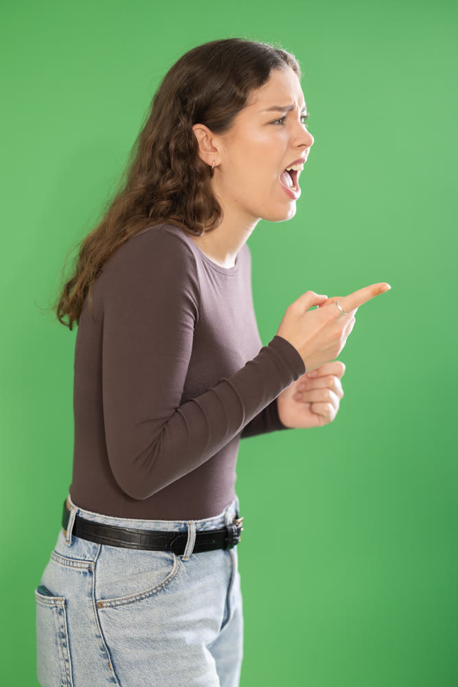 Outraged European young woman is yelling at someone