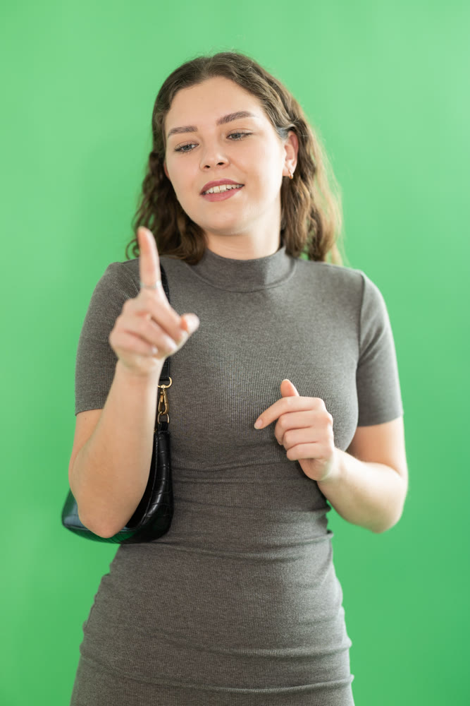 Young woman moves her finger across virtual screen