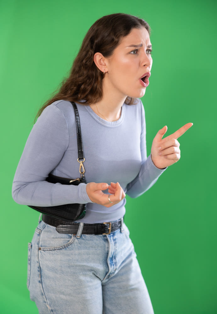 Outraged European young woman is yelling at someone