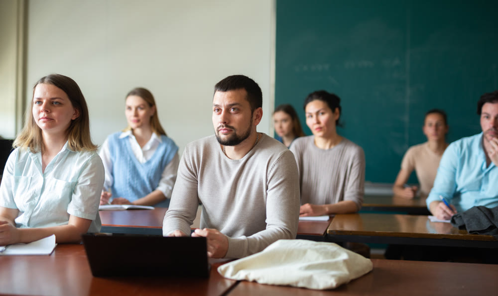 University students exercising in class room