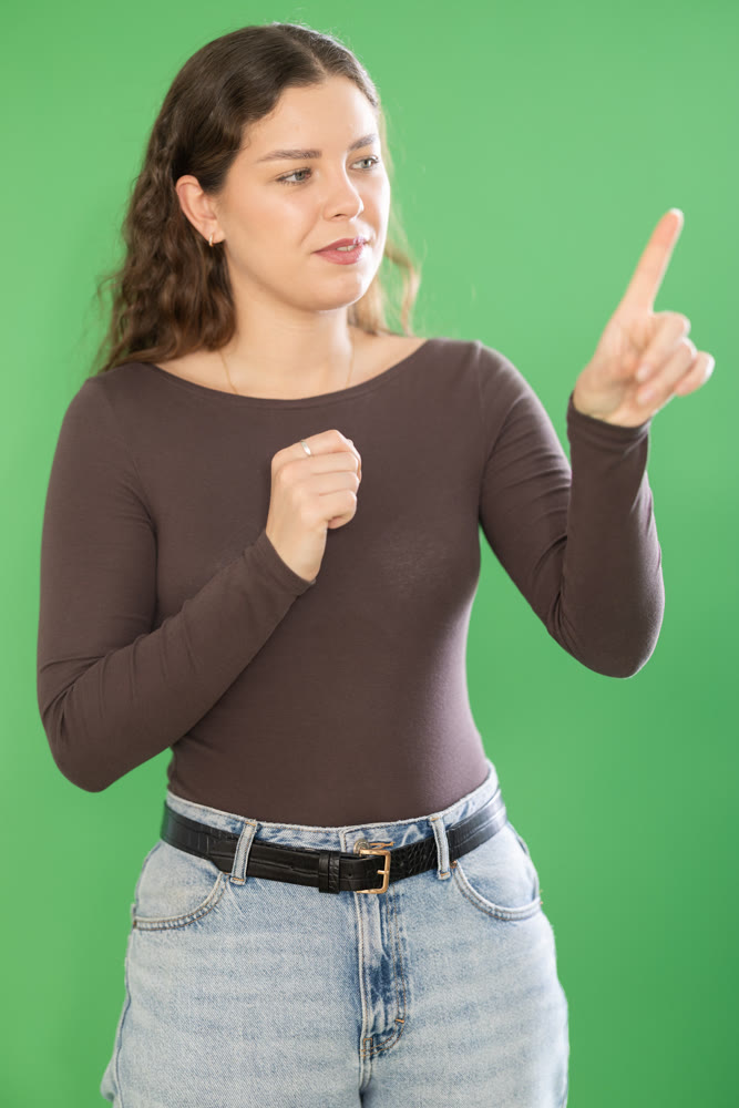 Young woman moves her finger across virtual screen