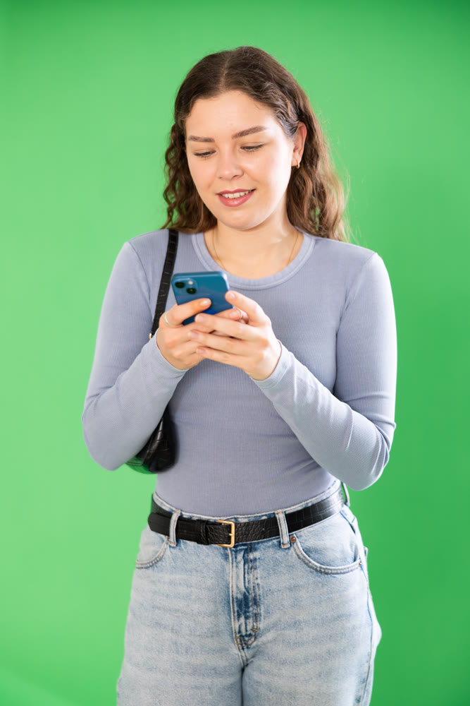 Female person girl scrolls phone screen or types text message