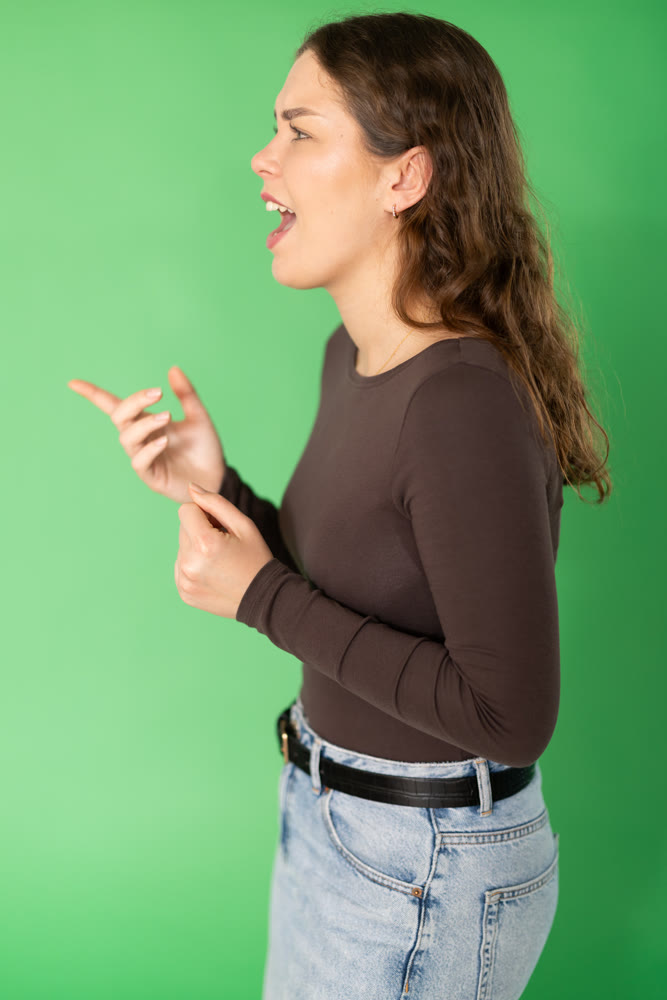 Outraged European young woman is yelling at someone