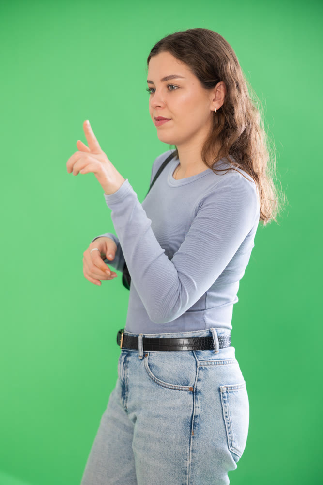 Young woman moves her finger across virtual screen