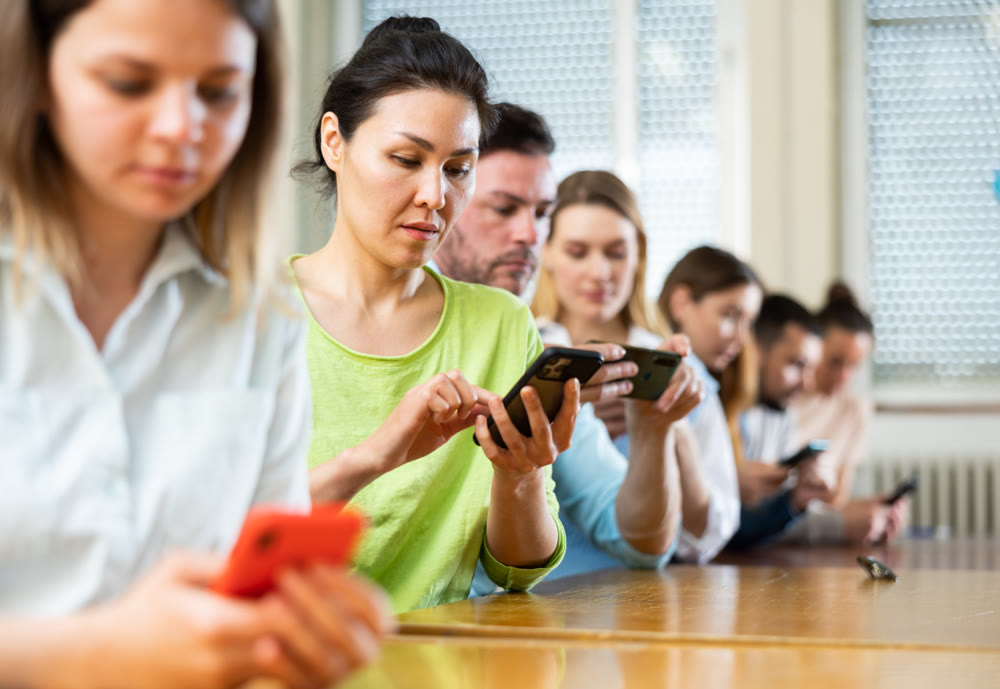 Woman student using smartphone in classroom