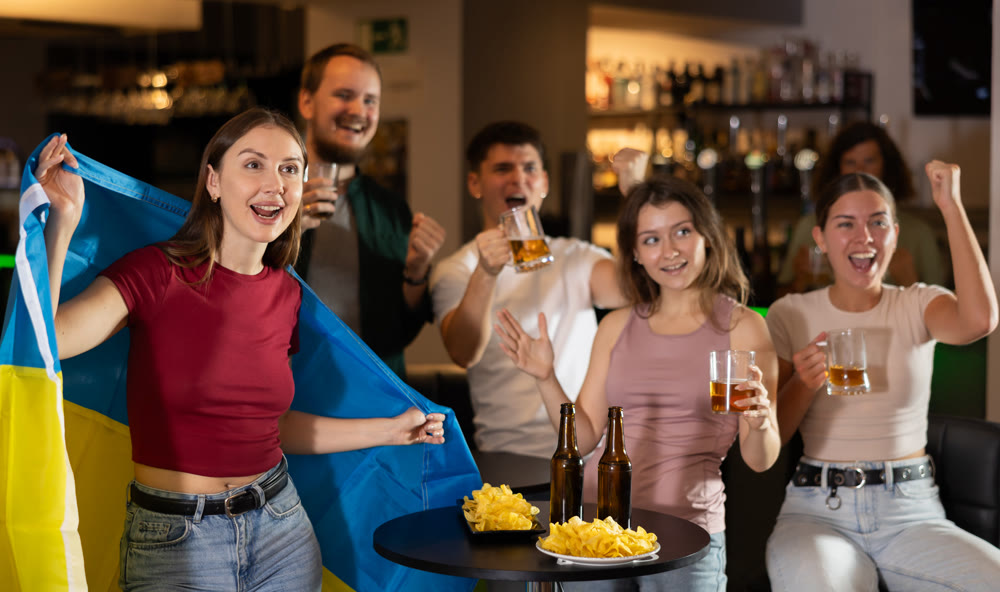 Group of fans in bar with Ukrainian flag