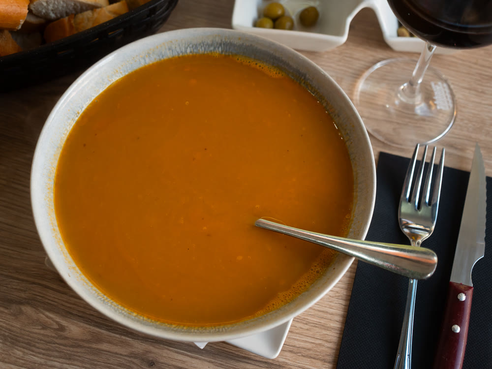 Traditional Spanish soup with seafood in a bowl view from above