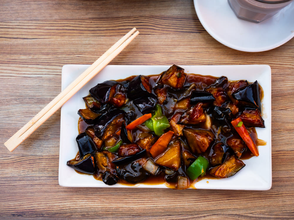 Fried eggplant slices with vegetables on a plate
