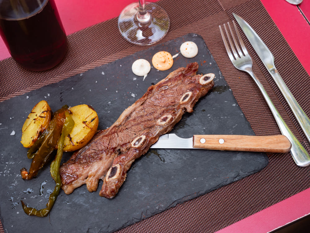 Grilled beef churrasco with roasted potatoes, peppers, and aioli