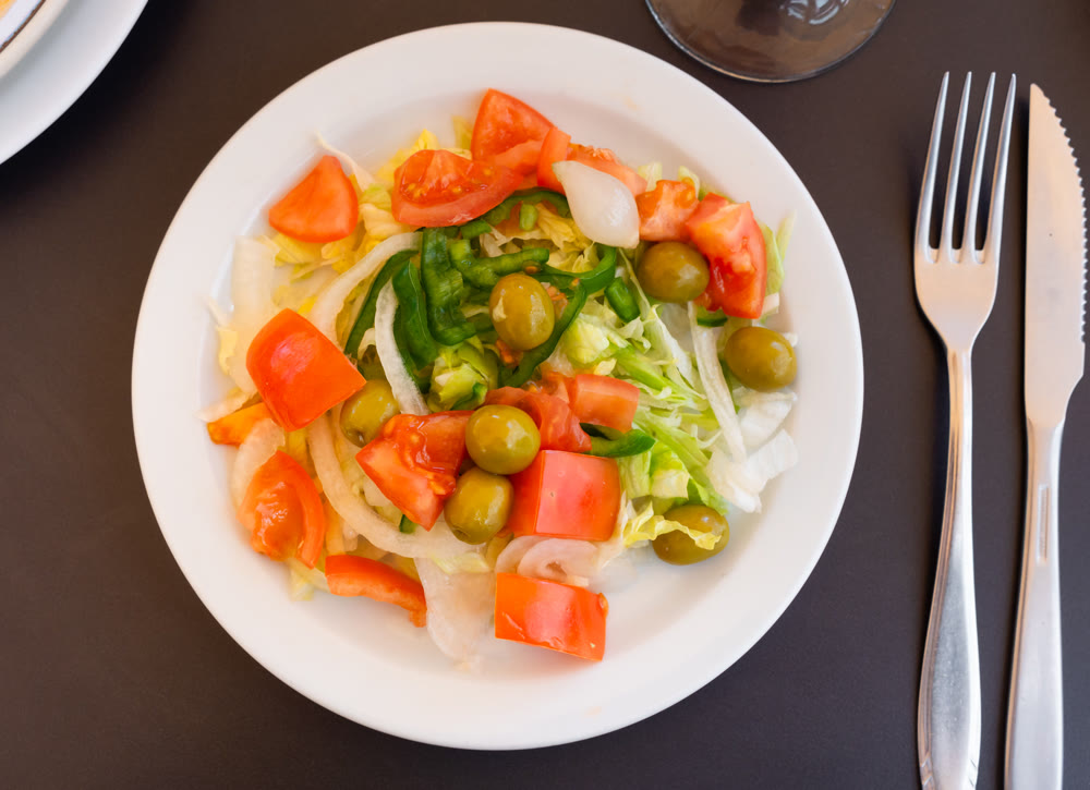 Fresh farm vegetable salad on a plate top view