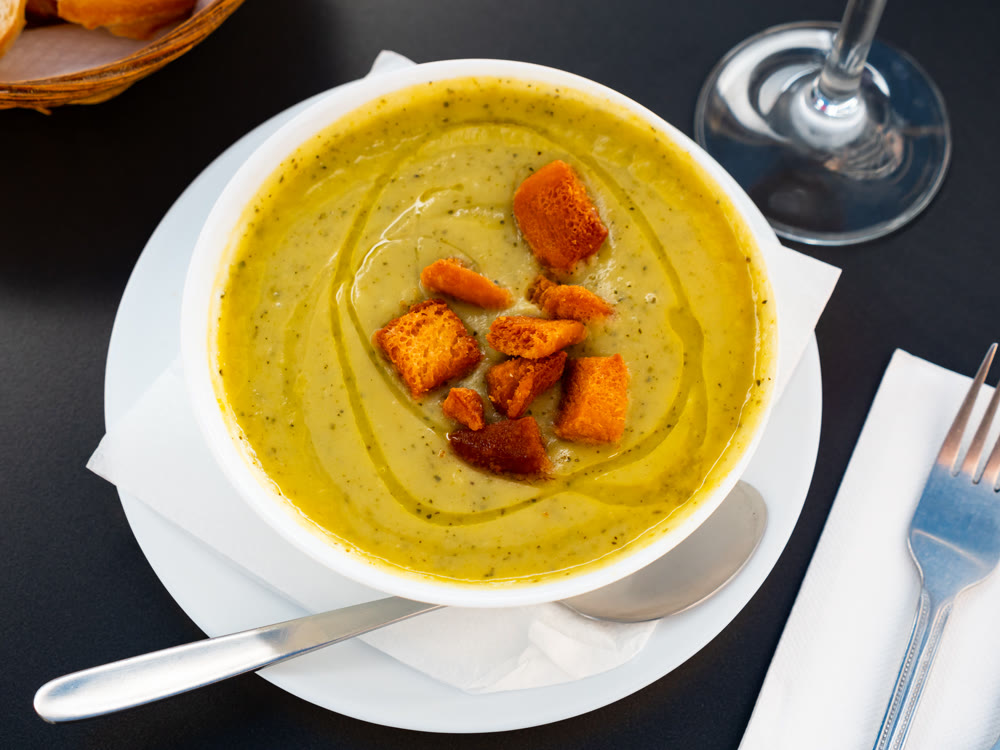 Creamy zucchini soup served with croutons