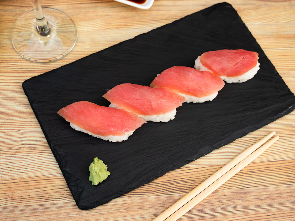 Nigiri de atun is classic Japanese dish that consists of small hand-formed ball of rice topped with slice of fresh tuna
