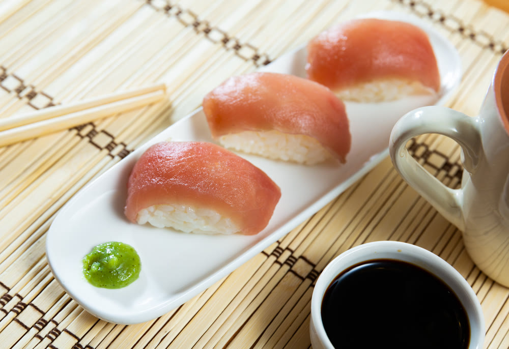 Nigiri de atun is classic Japanese dish that consists of small hand-formed ball of rice topped with slice of fresh tuna