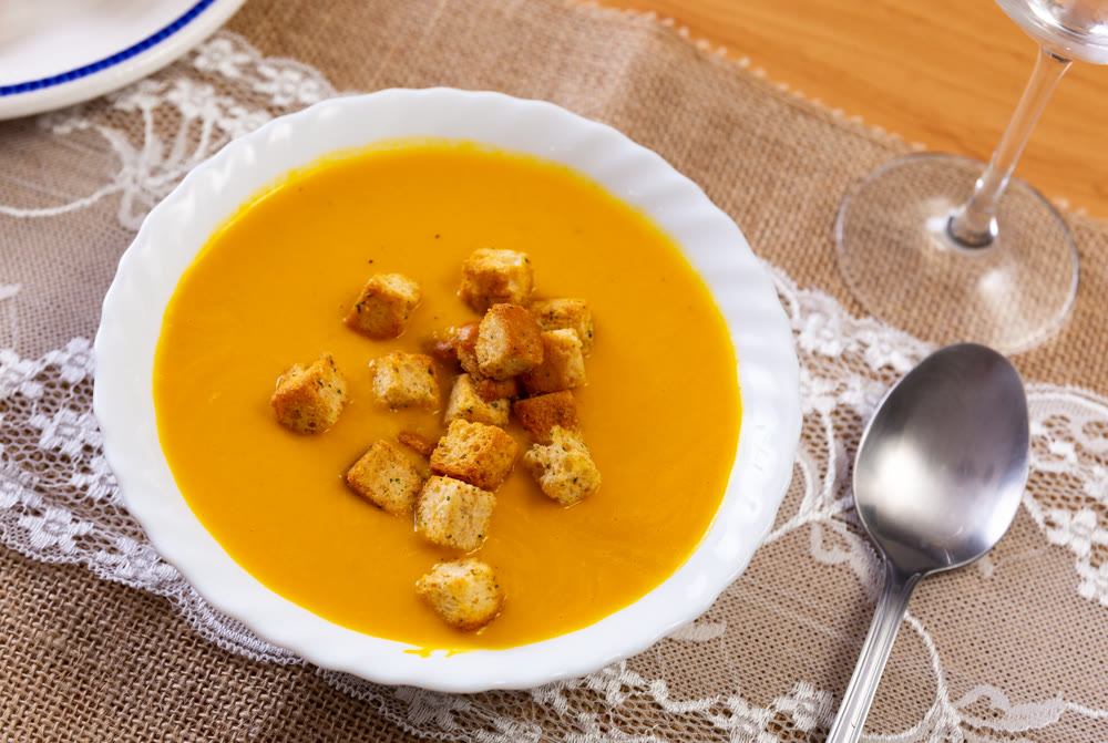 Creamy zucchini soup served with croutons