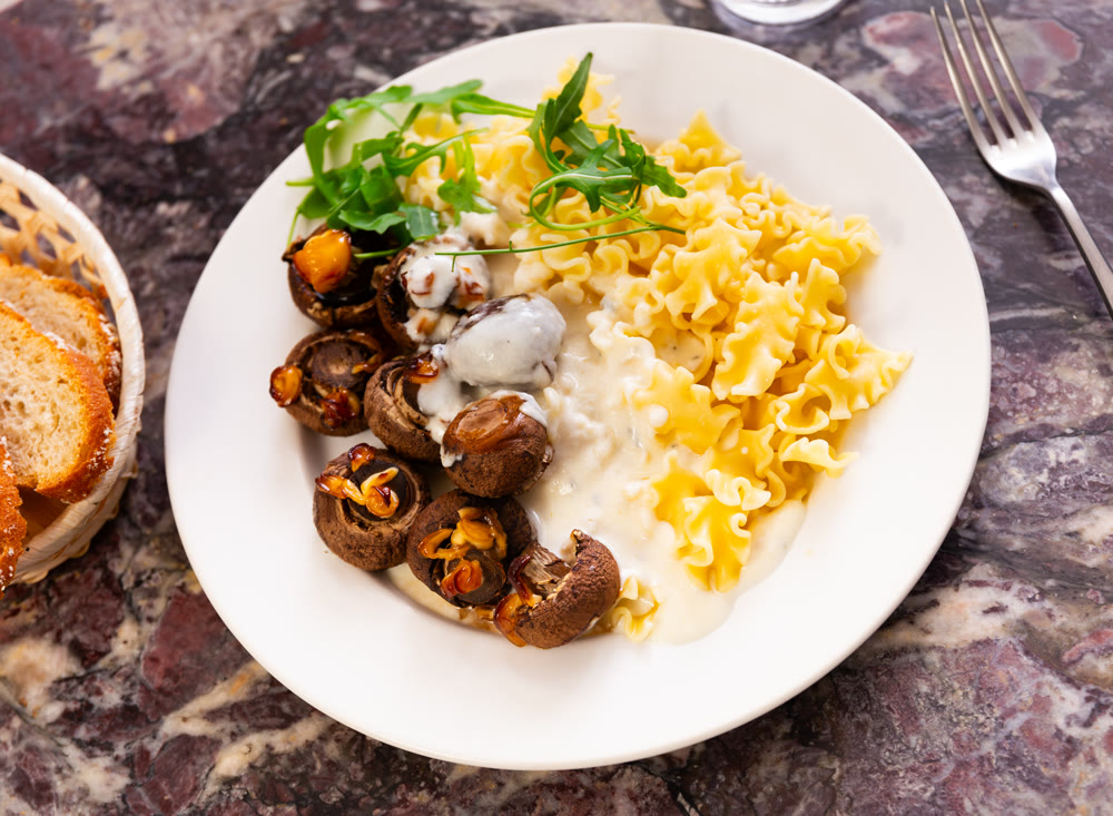 Italian pasta with mushrooms and arugula - a lunch dish