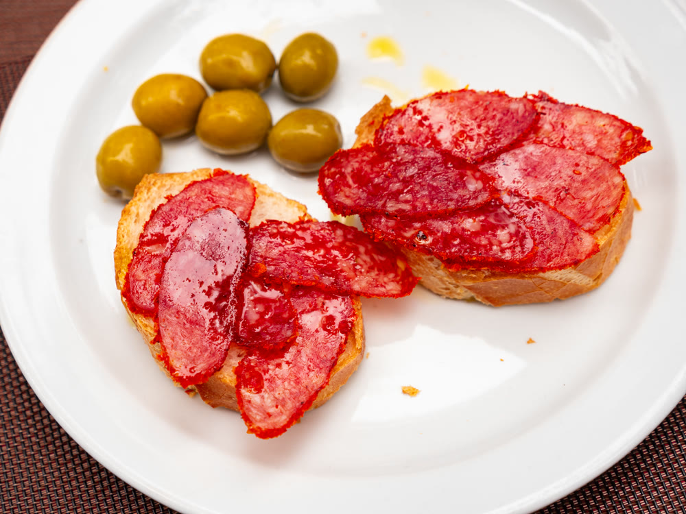 Tapas sandwich with pork sausage and olives