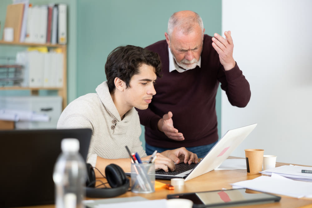 Mature male manager is dissatisfied with the work of an employee - yells and reproaches her