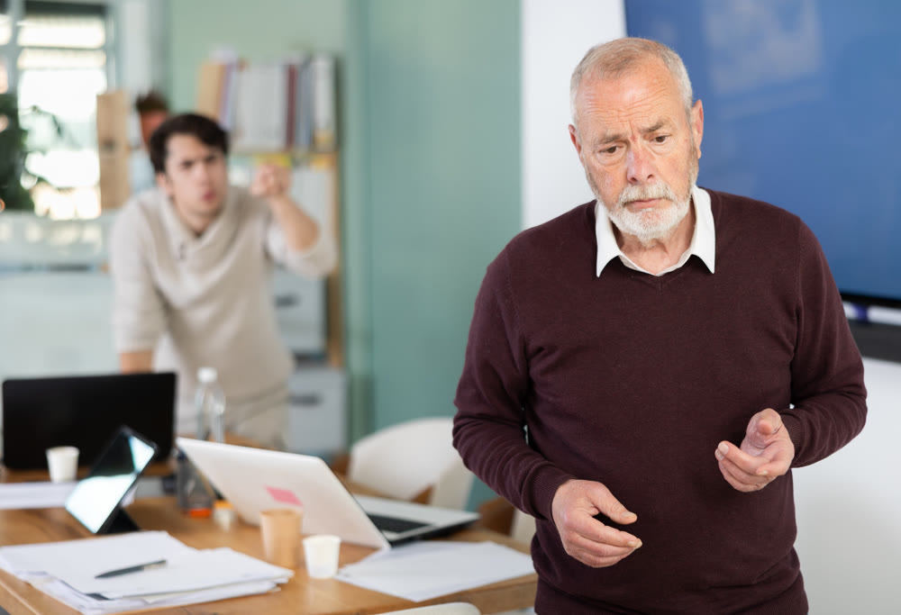 Outraged senior man turned his back on angry and shouting man boss.