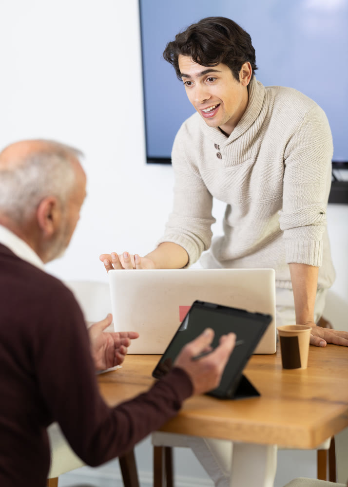 Two managers discuss work projects in company office