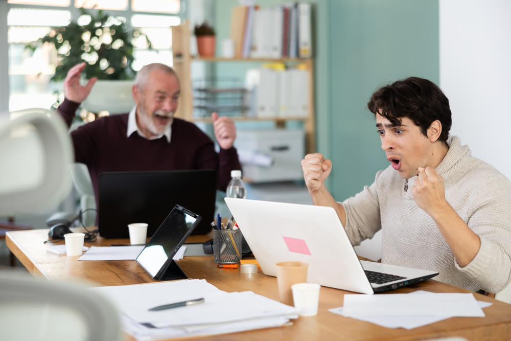 Men office employees is genuinely happy and elated