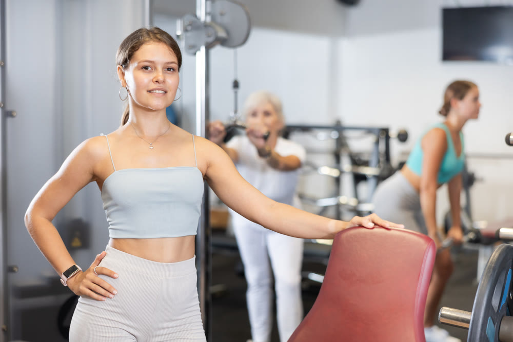 Portrait of slim woman smiling after work out in gym