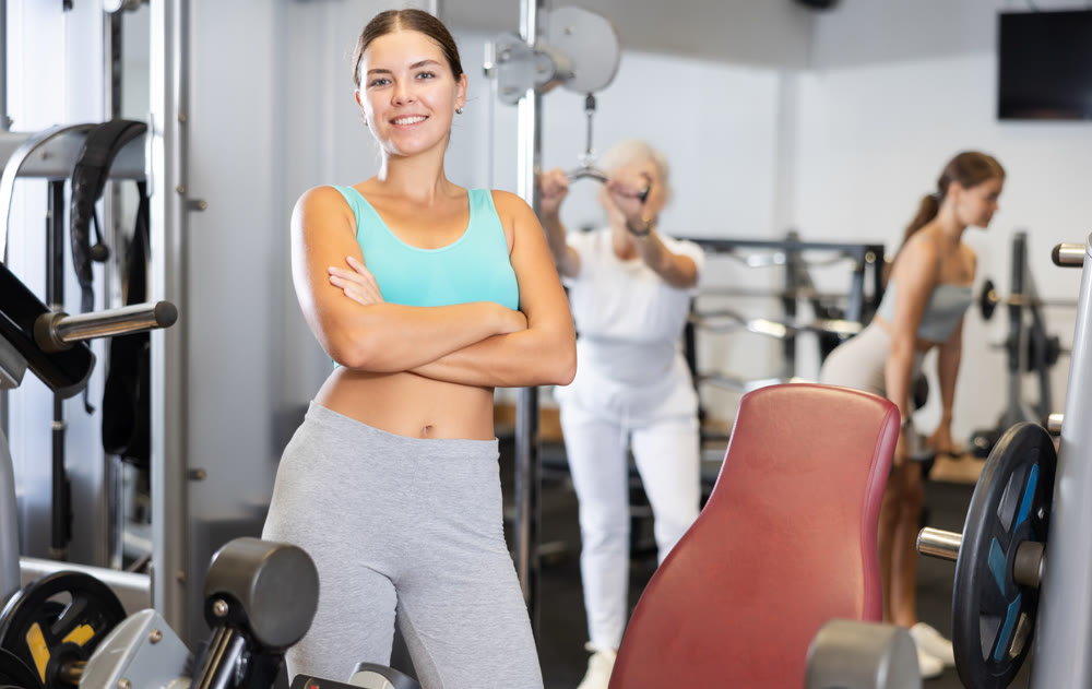 Young athletic woman posing in gym